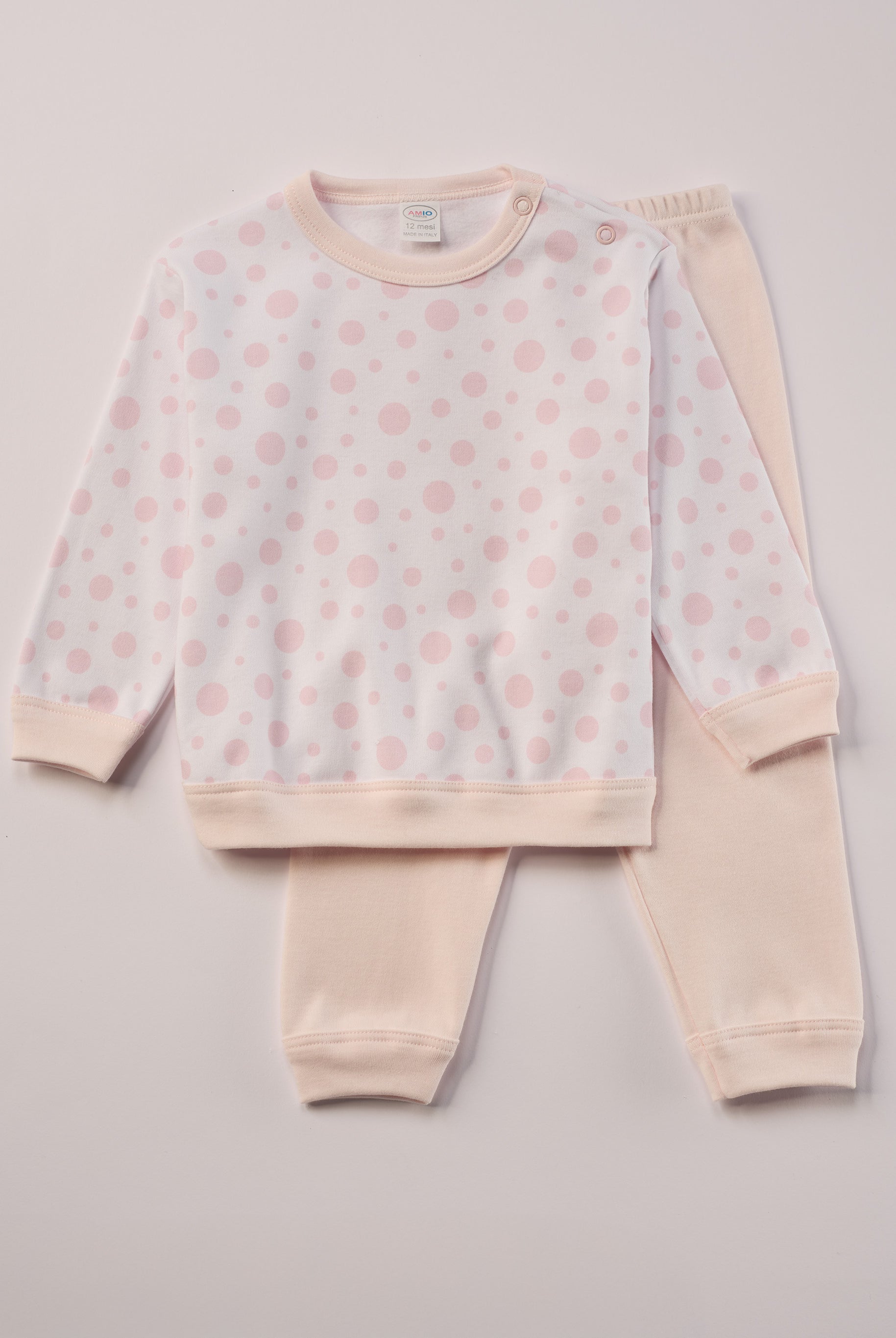 Für ruhige Nächte und gemütliche Morgenstunden. Dieser Pyjama für Babys & Kinder von 12 Monaten bis 3 Jahren besteht aus hochwertiger organischer Baumwolle und ist innen sanft angeraut. Das weiche Innenflanell sorgt für ein besonders angenehmes Tragegefühl und hält warm, ohne zu überhitzen. Gefertigt in Italien aus Stoffen italienischer Produktion – mit einem klaren Anspruch an Qualität, Langlebigkeit und kindgerechtem Komfort. Das verspielte Design, mit rosa gepunktetem Oberteil, ist zeitlos und niedlich.