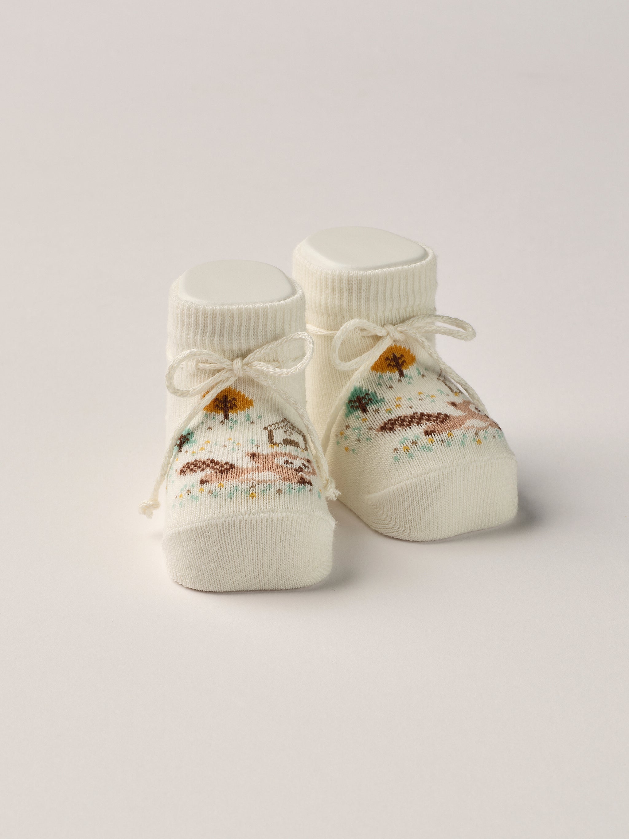 Die Baby Booties mit eingewebtem Waschbär Muster im Wald eignen sich perfekt als Geschenk für Babypartys oder als süße Schwangerschaftsankündigung für Freunde und Verwandte. Die feine Schnürung bietet besonderen Halt am Fuß. Unsere Scarpine werden in einer ansprechenden Geschenkbox präsentiert.&nbsp;

Höchste Qualität, bestes Preis-Leistungs-Verhältnis MADE IN ITALY.